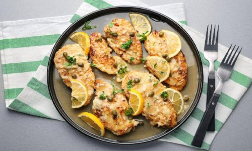Chicken Piccata, Zoodles & Veggies - Low Carb. Organic chicken breasts (two) are seasoned with spices, lightly floured with almond flour pan fried, and topped with parmesan cheese. Served with lemon caper piccata sauce on the side.  This is a fantastic recipe that is low in calories and low in carbs, served over power greens, with zoodles and veggies.