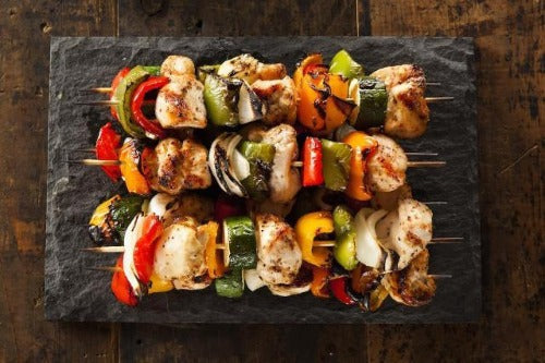 Grilled tender chicken breasts, delicious vegetables are served over rice pilaf