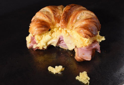 Breakfast Croissant with Ham, Eggs and Cheese. You will love our flaky French butter croissant, stuffed with soft scrambled eggs, American cheese and honey ham.