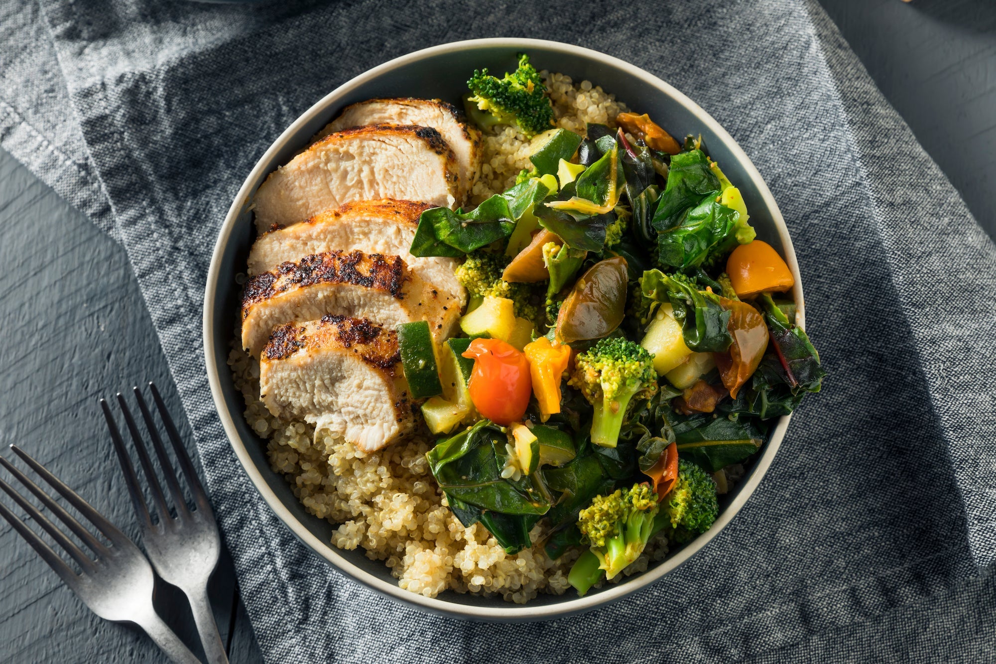 Chicken, Quinoa, Roasted Vegetables. Grilled tender chicken breast sliced and served over healthy quinoa and delicious roasted vegetables.