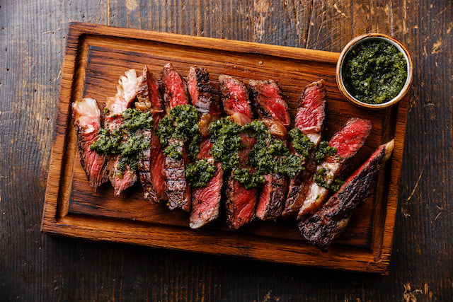 Chimichurri Steak - Low Carb. Our juicy skirt steak is bursting with juicy rich flavor. Marinated overnight for outstanding flavor with exceptional marbling and tenderness.  Our skirt steak is served rare with herb Chimichurri  pesto and seasonal veggies.