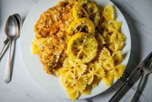 Chicken Française.Our oven fried organic chicken breasts are basted with basil citrus seasoning and topped with parmesan cheese. Served with bow tie pasta tossed in a light EVOO lemon zest and white wine sauce. This dish is simply delicious, low fat and low in sodium.