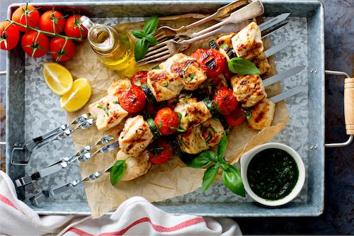 Grilled Chicken Skinny Bites - Low Carb. This recipe will be your favorite skinny low carb dish. Our grilled chicken breasts are marinated in olive oil, lime juice and honey and basted with a mild Sriracha sauce. Served over spinach with red peppers, zucchini and squash.